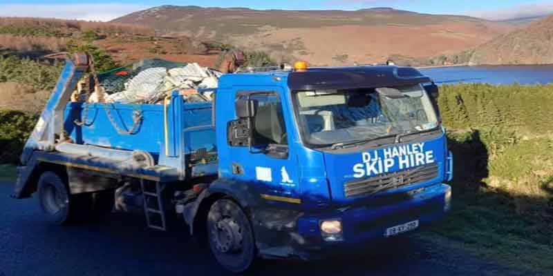 What Can I Put In A Skip Blog Post Image of a DJ Hanley Skip Truck Driving Through The Mountains.